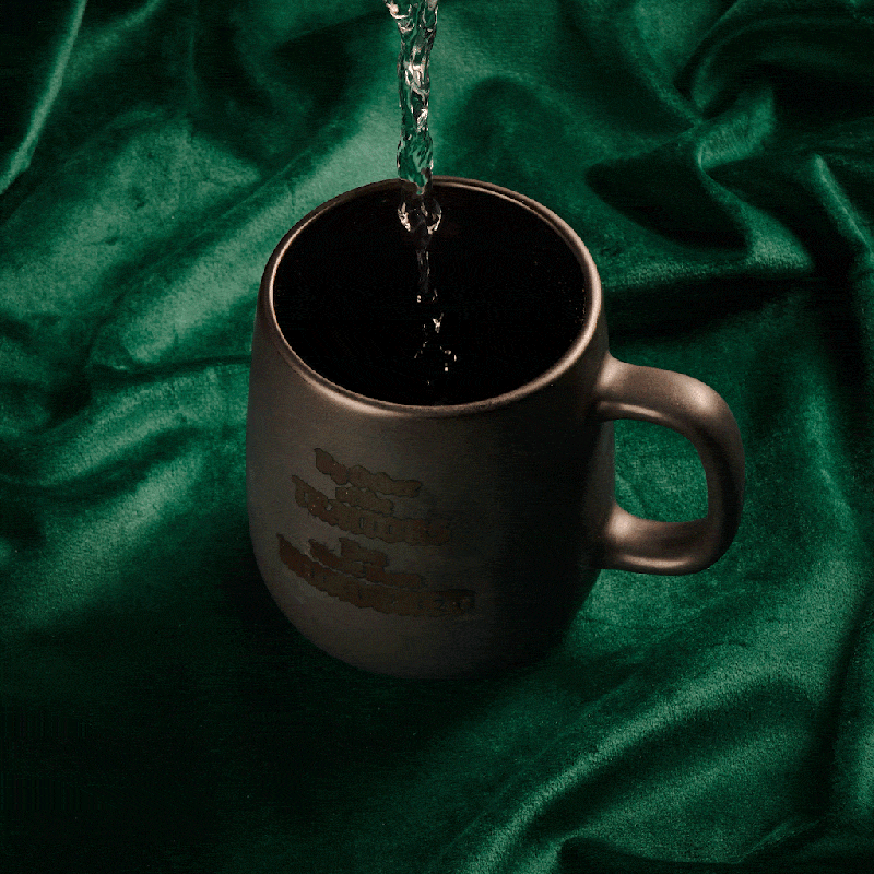 Hot water being poured into a cup, showing the text on the cup changing colour.